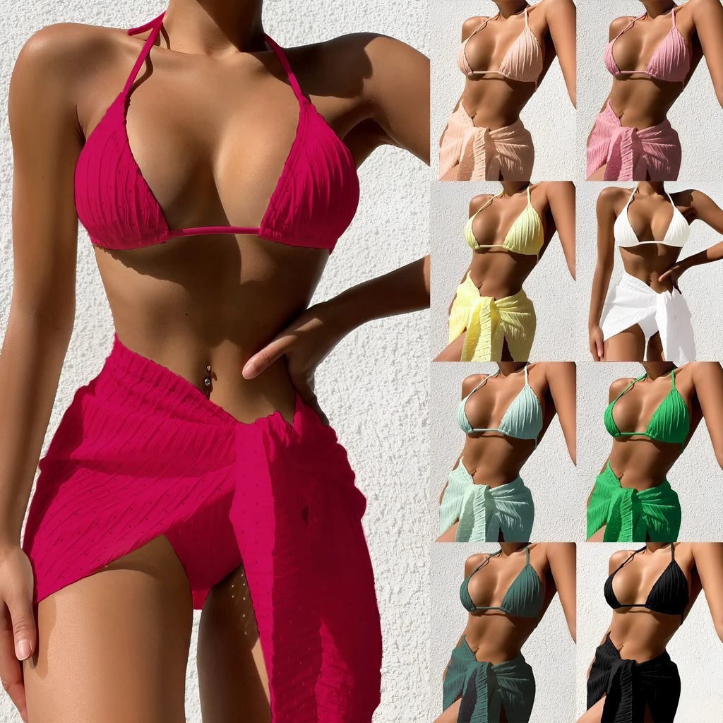 Women's halterneck backless bikini with a matching mesh skirt in a solid colour.
