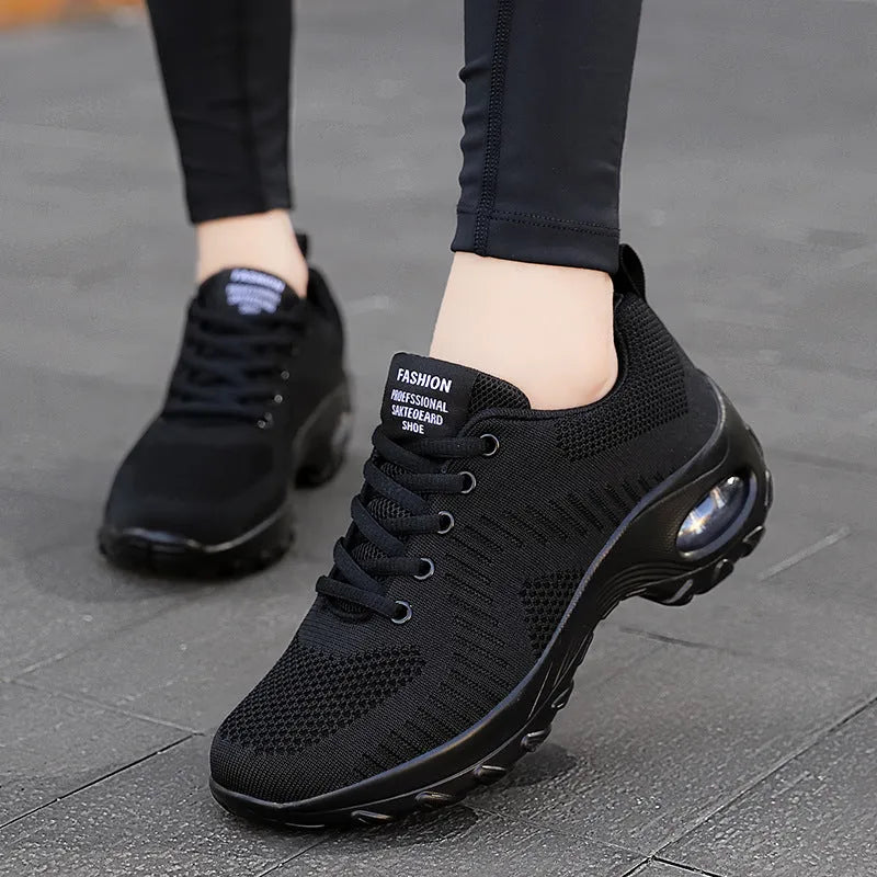 Women's red and black mesh low top sneakers with front lace-up and round toe design