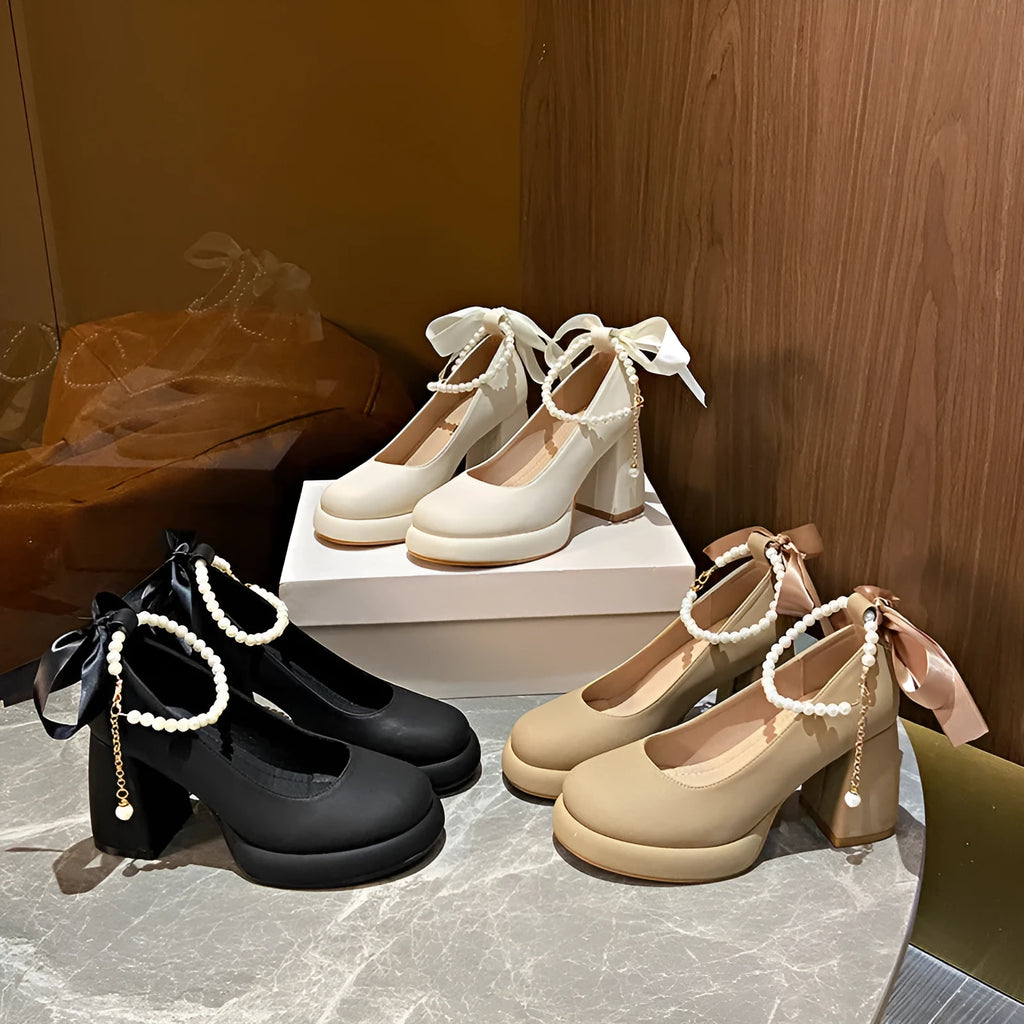 Women's beige Mary Jane shoes with chunky heel, round toe, and ankle strap with pearl buckle.