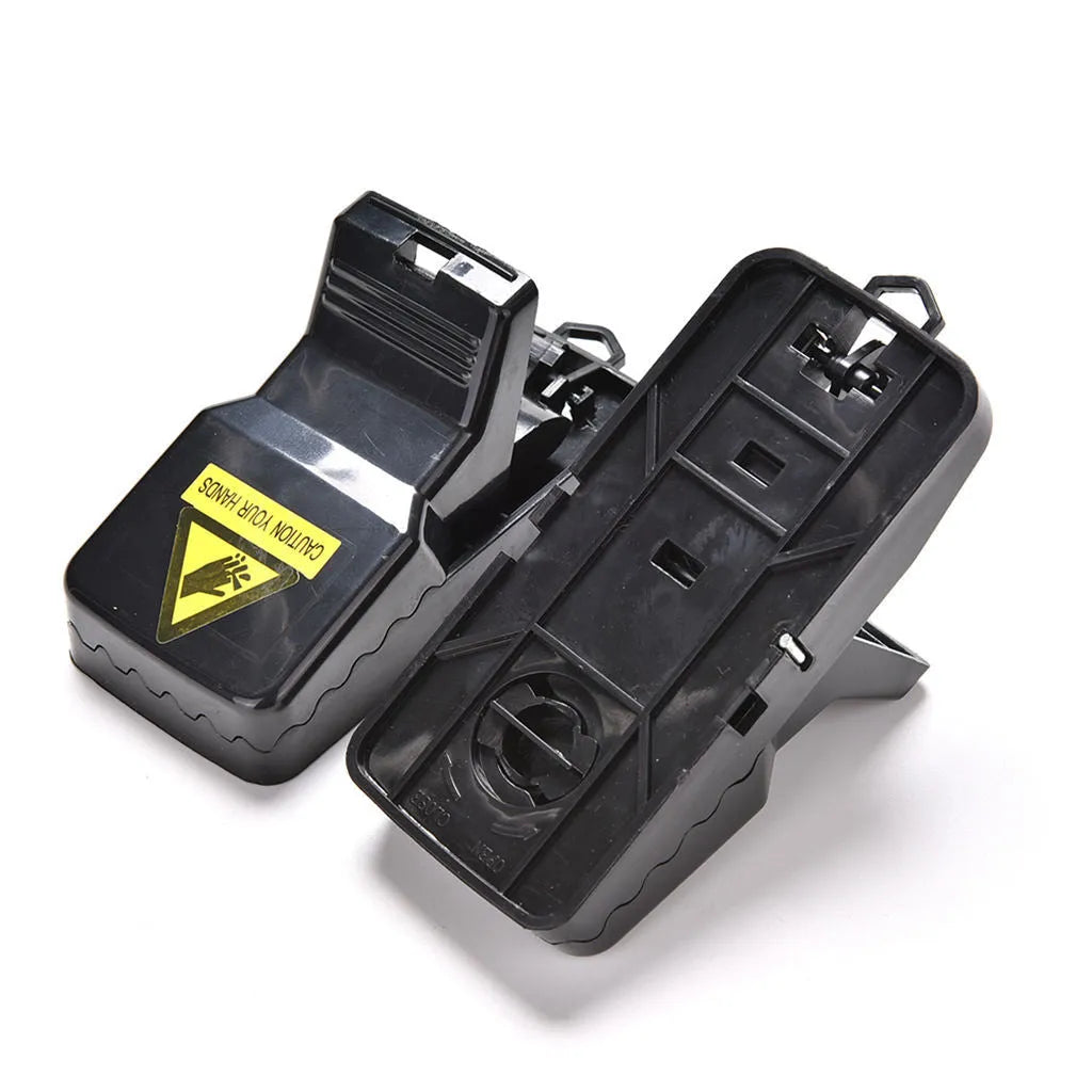 Six black plastic snap-action mousetraps showing their size and smooth surface.