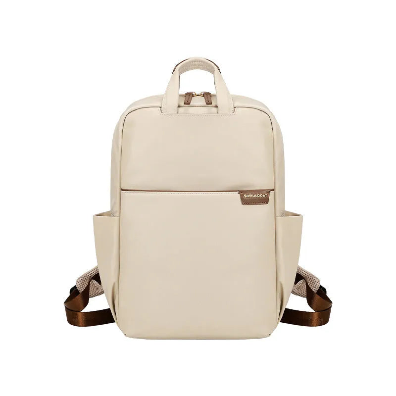 Nylon women's travel backpack in apricot colour showing front pockets and laptop compartment.