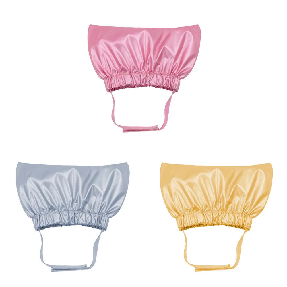 A silver adjustable waterproof shower cap for a dog or cat on a non-woven fabric background.