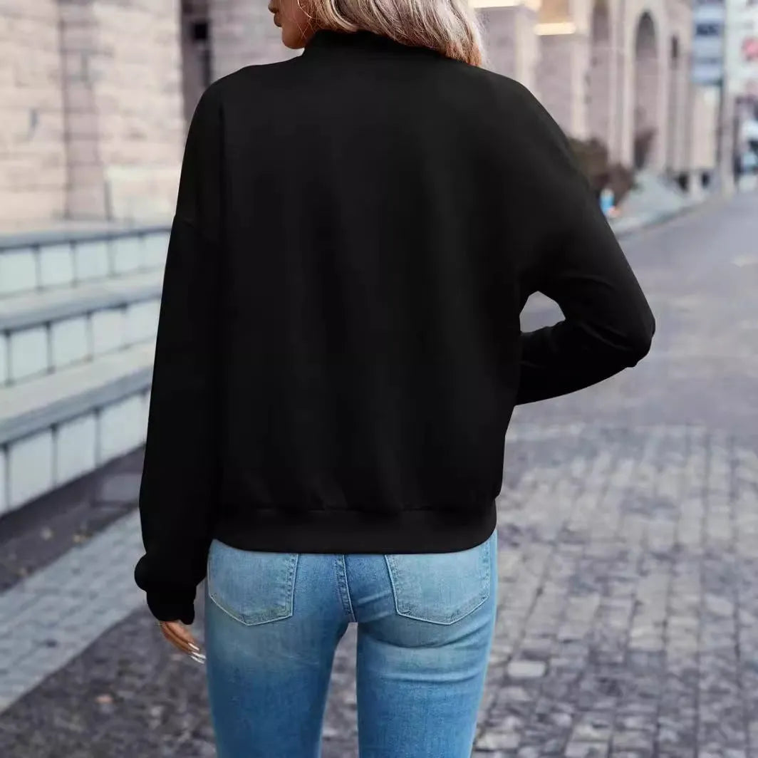Black women's zip jacket with faux pockets and long sleeves on hanger