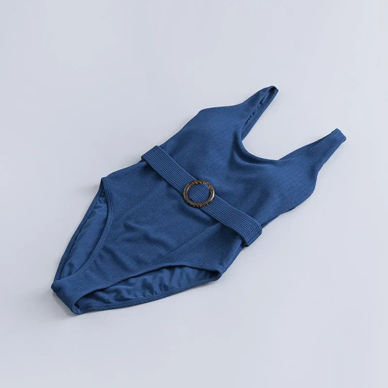 Navy blue women's one-piece slimming swimsuit with triangle top and chest pads on a white background.