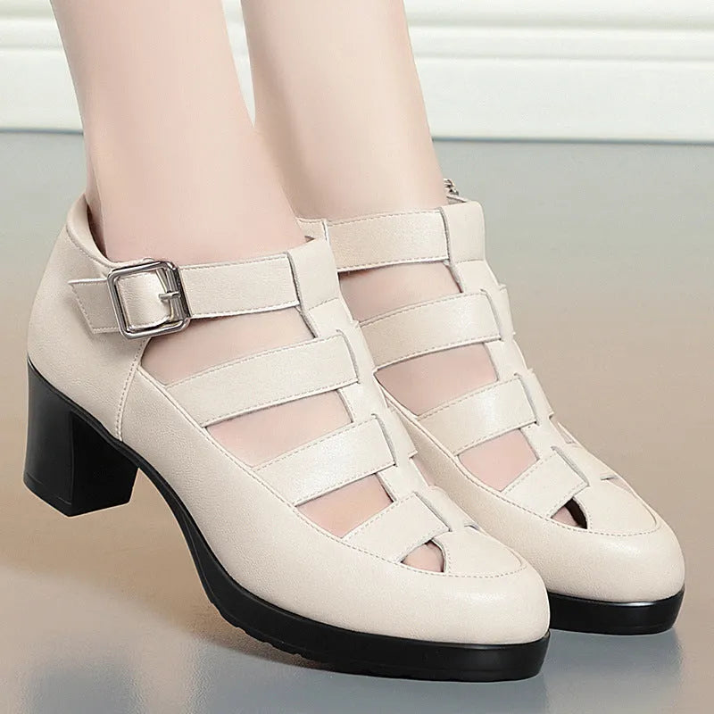 Women's beige closed toe sandals with a chunky heel, woven upper, ankle strap buckle, and back zipper.