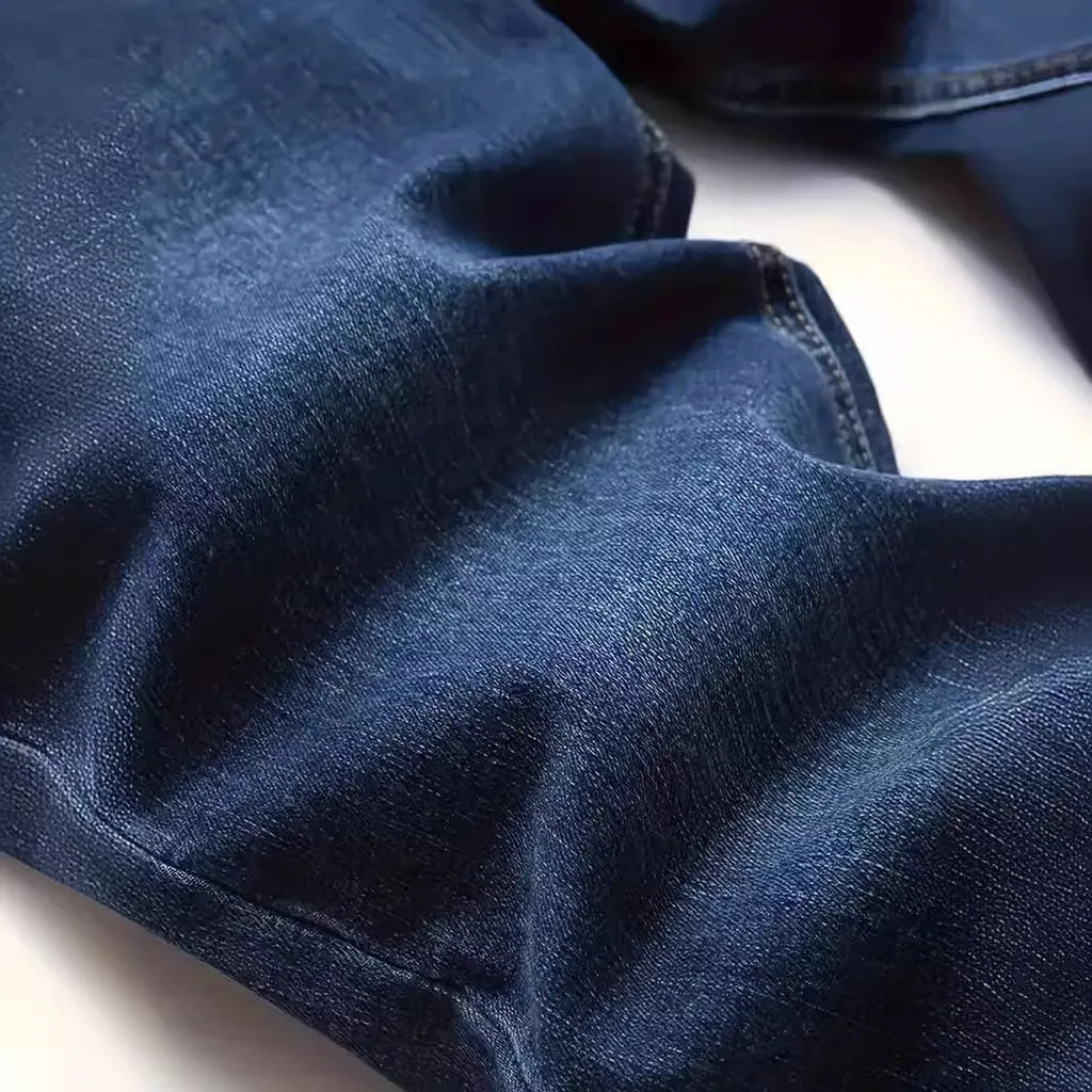 Men's dark blue slim fit casual jeans with skinny leg opening and mid waist