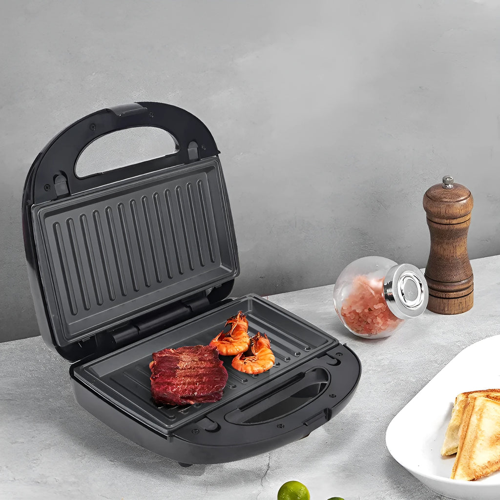 Black electric sandwich pan with double-sided heating, exchangeable plates, and brushed stainless steel cover