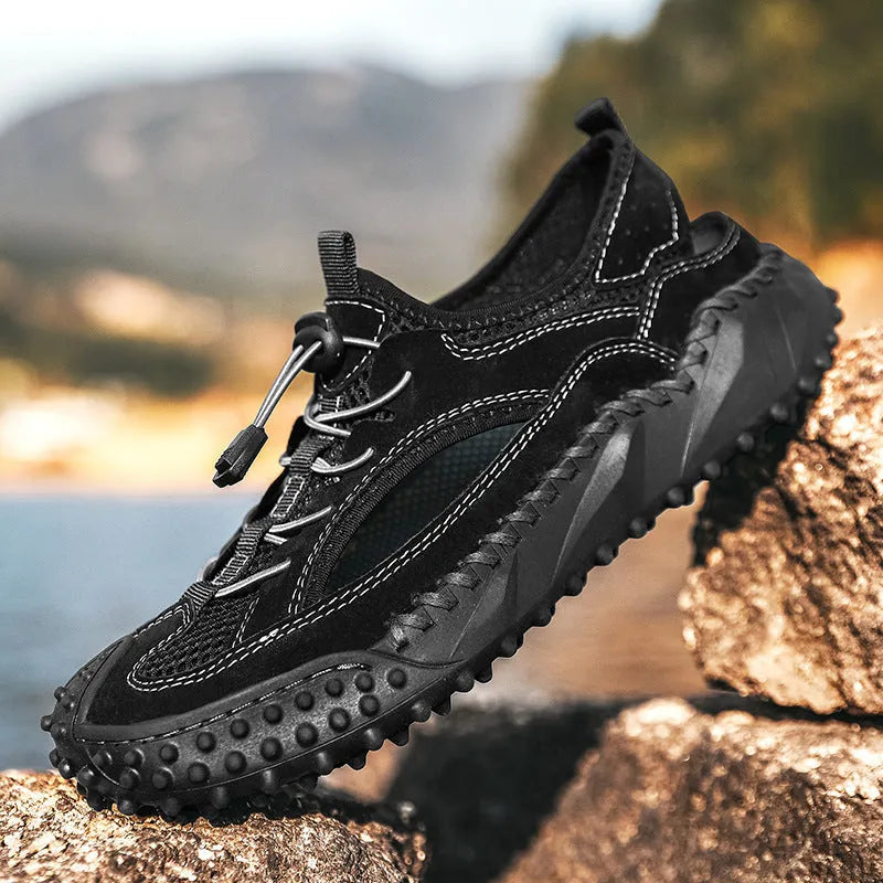 Men's black sports sandal with leather mesh upper, elastic band, and textured rubber sole.