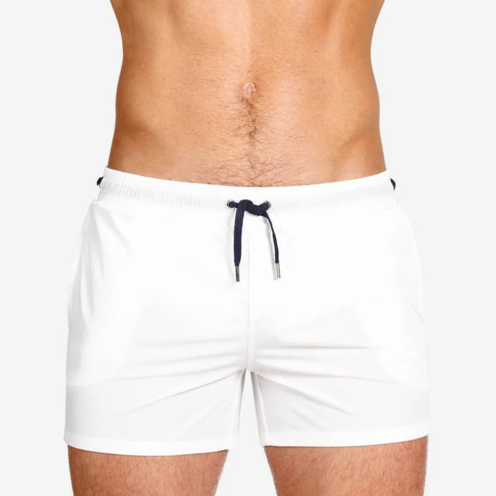 Men's solid colour swimming shorts with mesh lining for sports and fitness activities