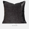 Grey and white plaid polyester bed runner blanket with matching pillowcase and leather round pillow on a double bed.