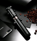 Black Bluetooth selfie stick tripod with remote control extended next to mobile phone
