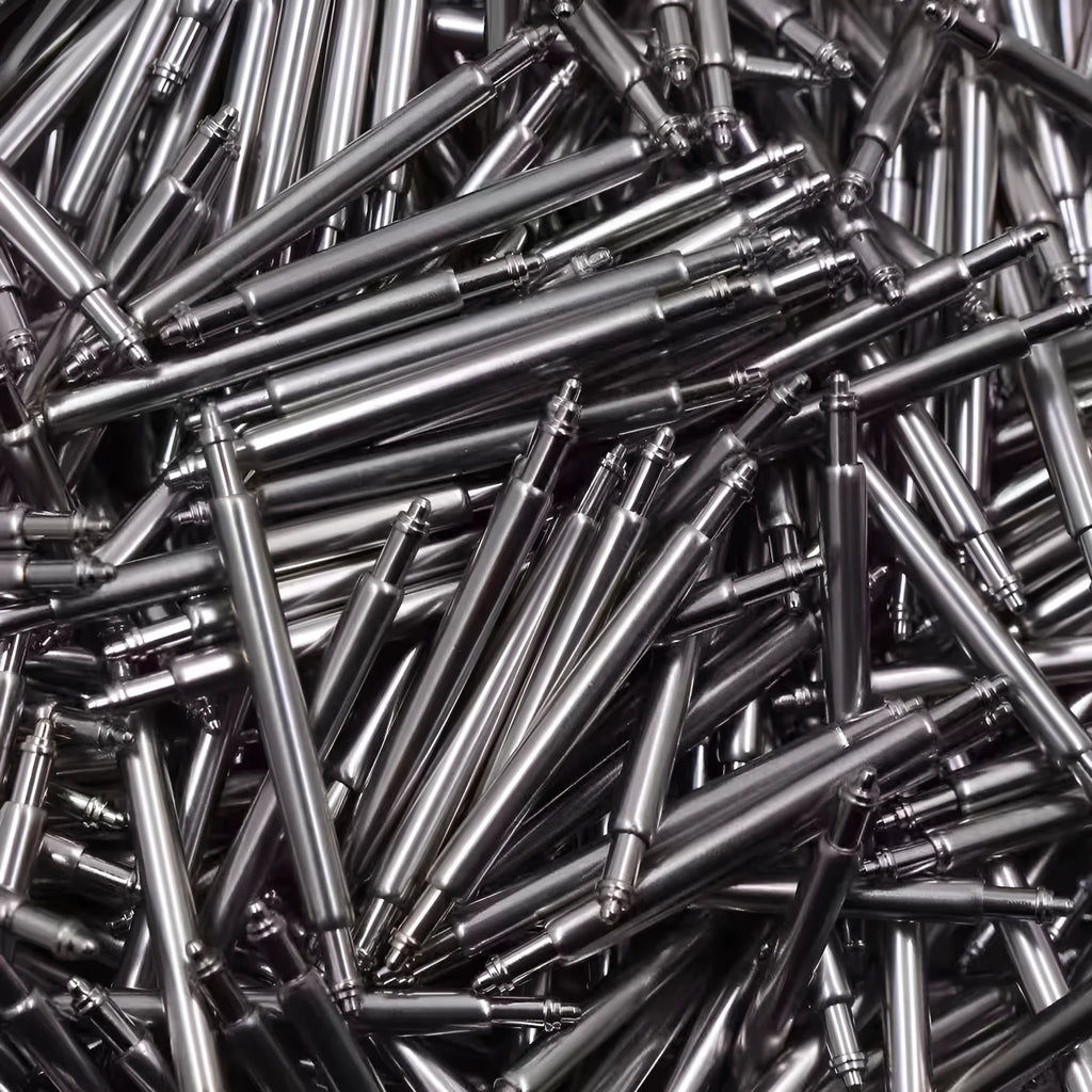 Bulk assortment of watch bolt auricular needle spring shafts in sizes 21mm to 26mm for repair.