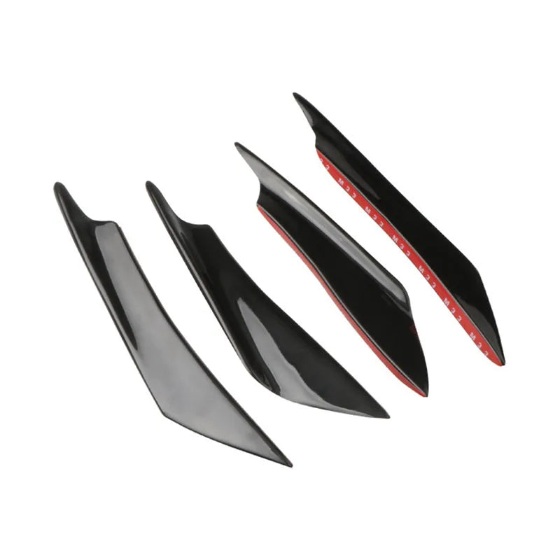 Set of four black ABS plastic bumper blade spoilers for car modification on a white background.