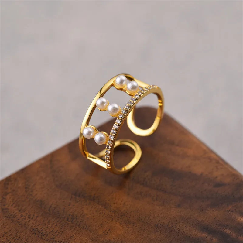 Women's geometric open ring in electroplated gold colour on a copper base.