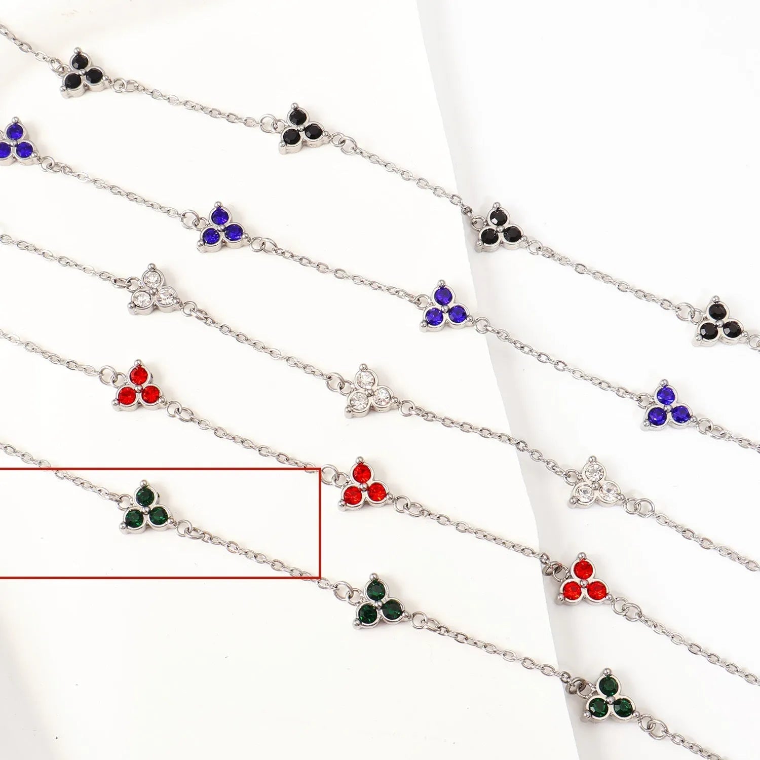Women's stainless steel geometric triangle bracelet with a three-diamond pattern, shown in a gold and white zircon colour option.
