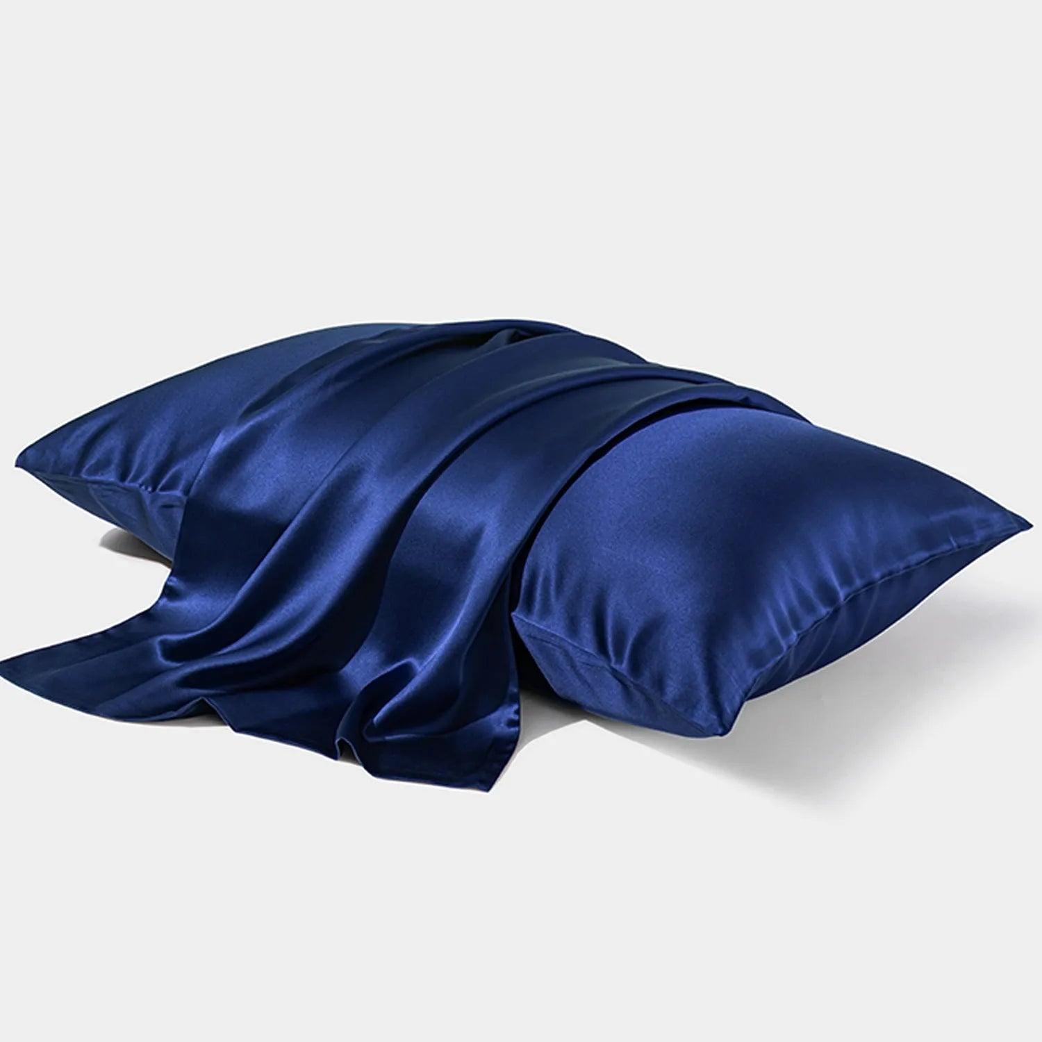 Dark grey silk pillowcase with envelope closure, shown flat and on a pillow.