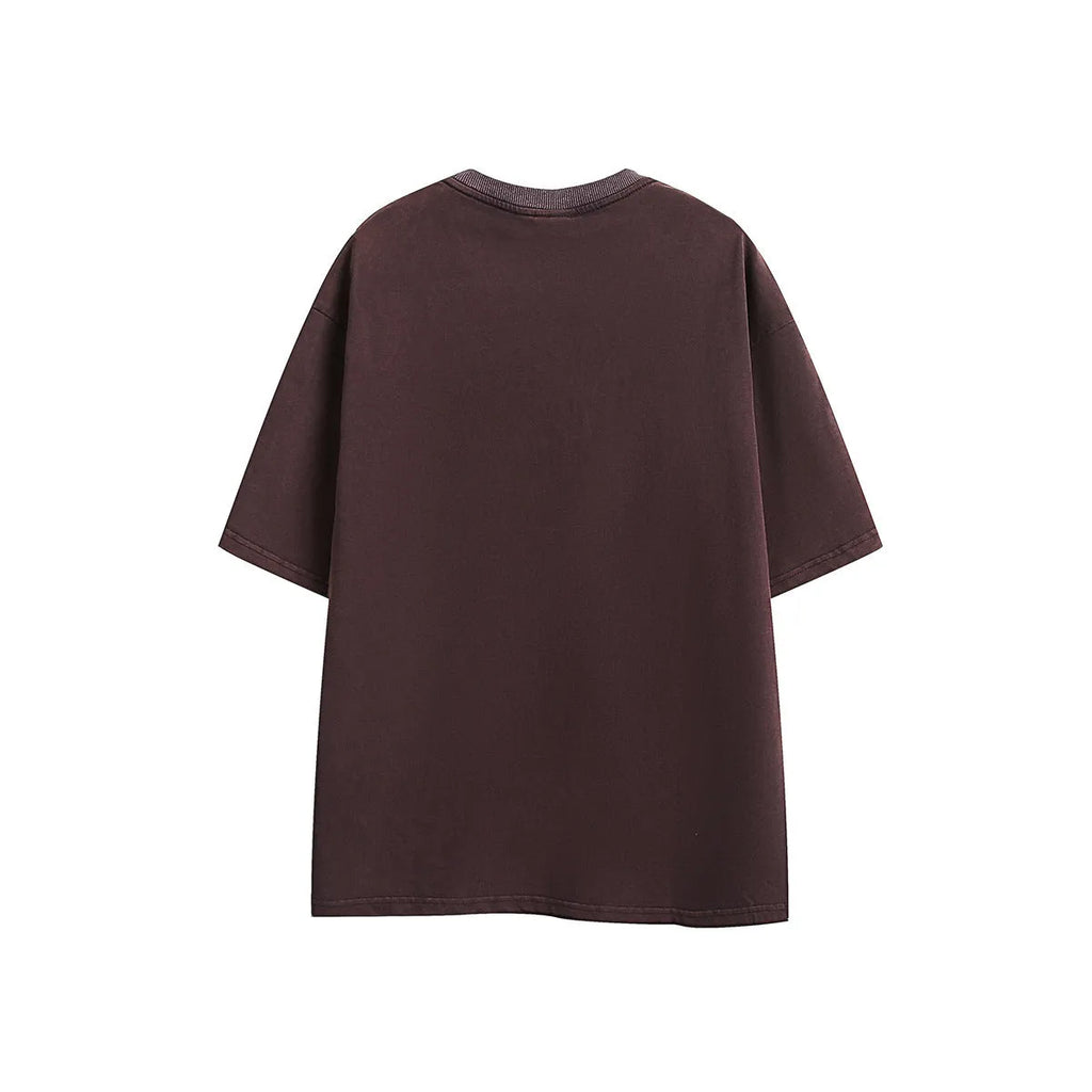 Purple and black loose-fit short-sleeved cotton t-shirt with embroidered retro design on a washed fabric.