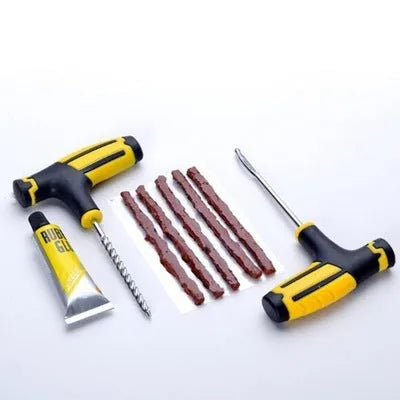 Black and yellow vacuum tyre repair tool kit with probe, pin, glue, and rubber strips.