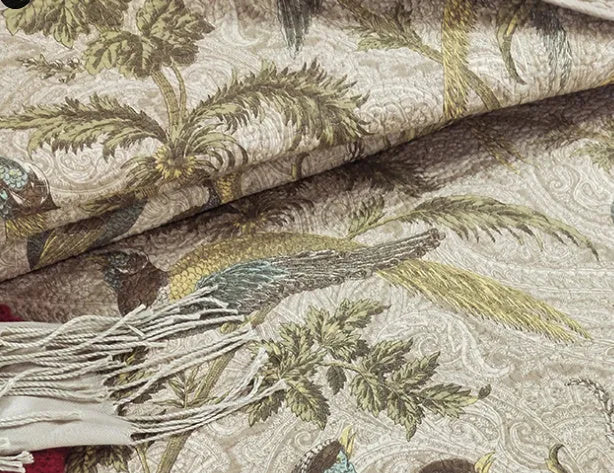 Blue American floral and bird print cotton quilted bedspread set with matching sheet on a bed.
