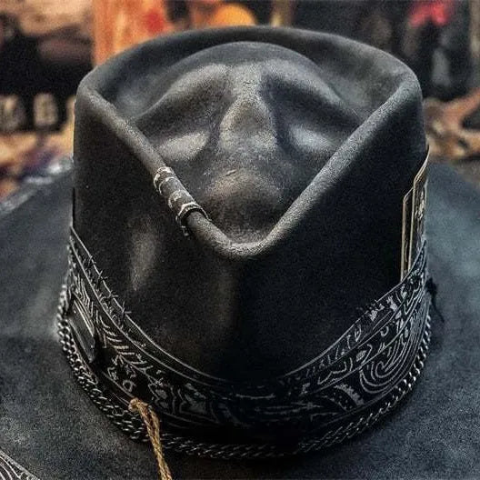 Handmade wool felt skull hat with a conical crown on a neutral background