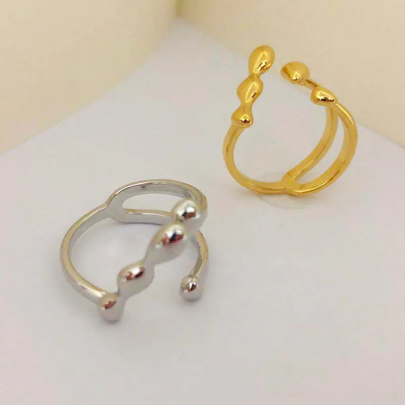 Adjustable brass opening ring with spherical design in gold or silver colour
