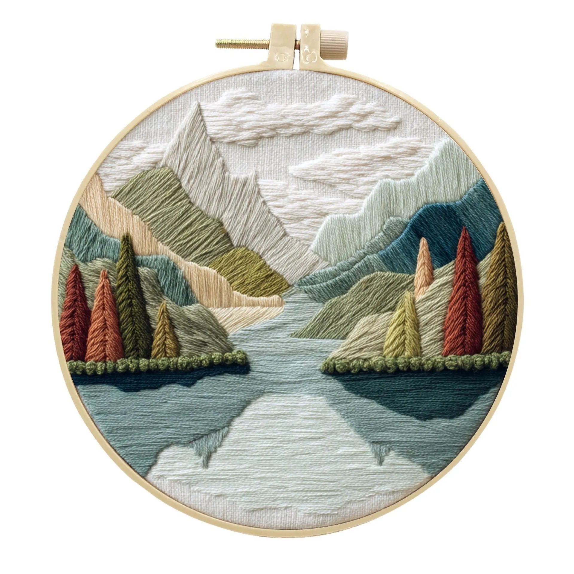 Embroidery kit with printed landscape fabric, thread, bamboo frame, and needles arranged for DIY cloth art