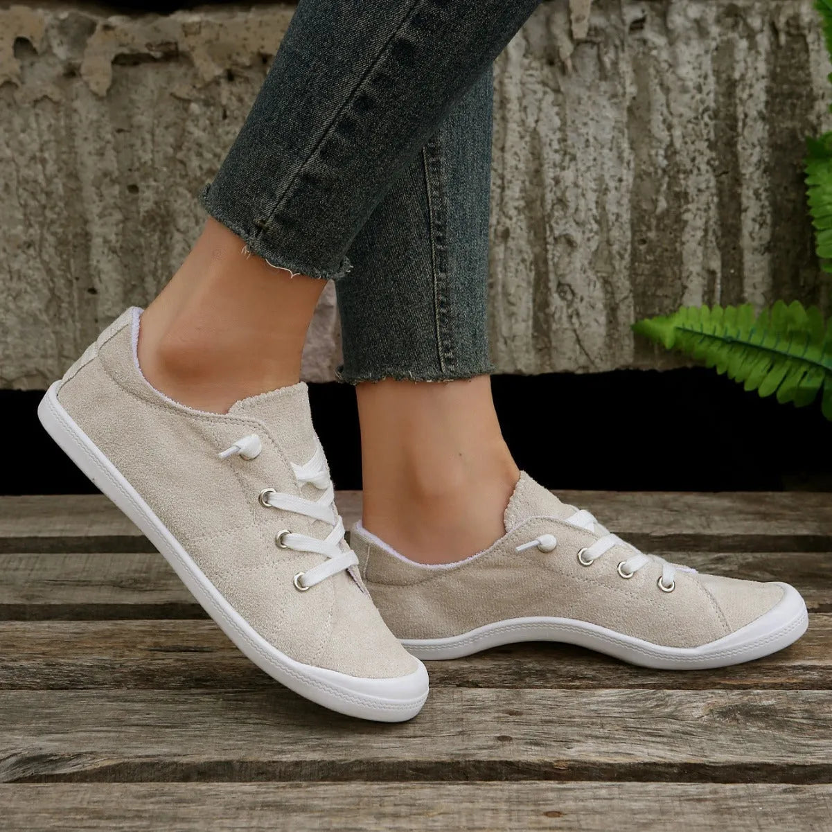 Women's creamy white casual sneakers with fabric upper and rubber sole on multiple surfaces