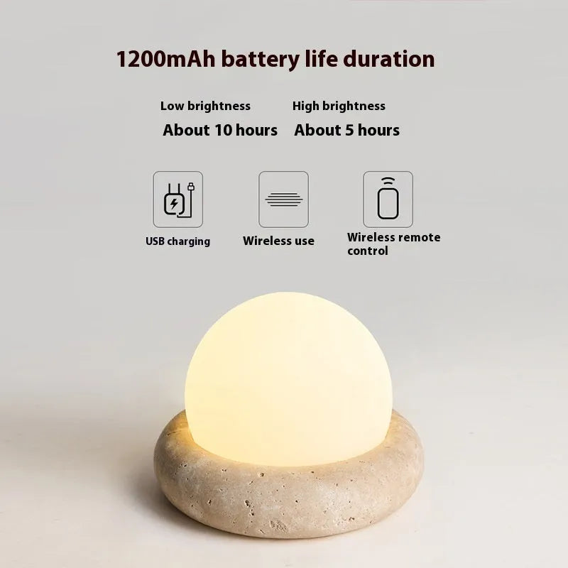 Cream modern bedside remote control night lamp with yellow cave stone light on bedside table