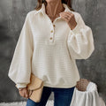 Women's milky white sweater with a polo collar and long sleeves laid flat.