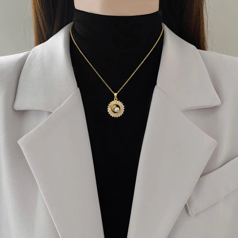 A titanium steel jewellery set with a square diamond and leaf design necklace and matching stud earrings.