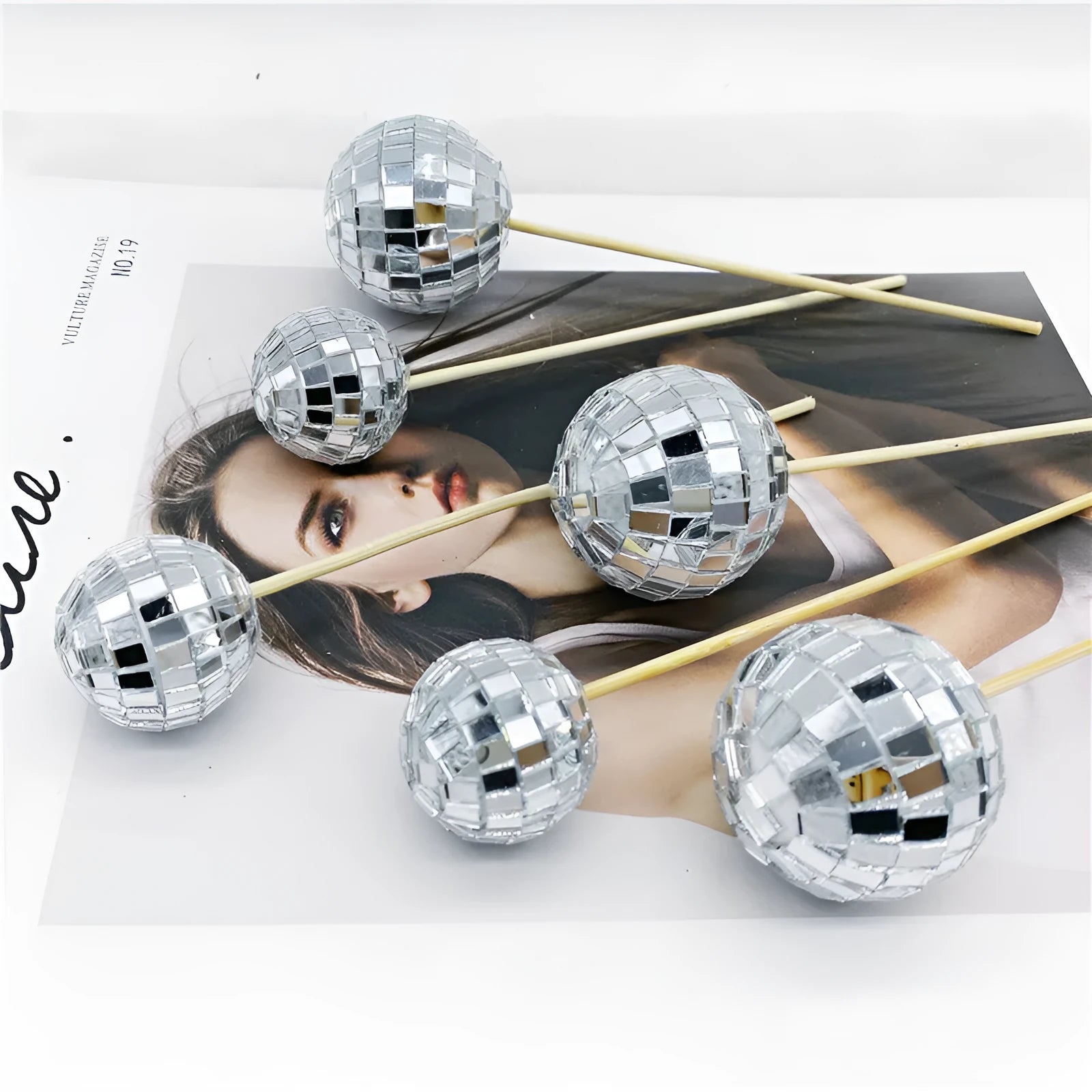Glass disco ball cake decoration on a wooden stick, shown in different sizes for cake topping.