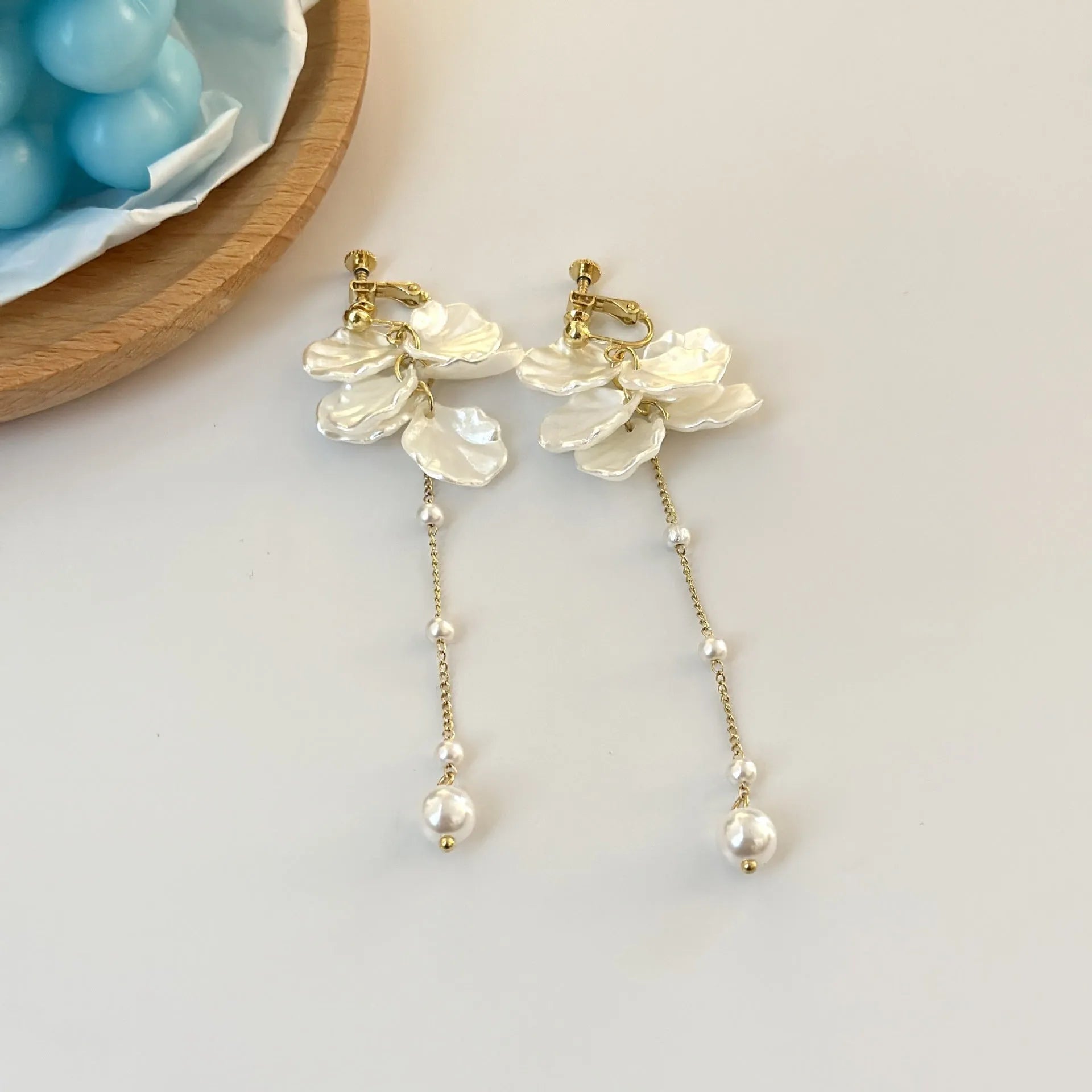 Women's acrylic shell pearl tassel earrings showing four different clip style options