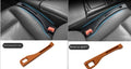 Black car gap storage box with handle positioned between car seats
