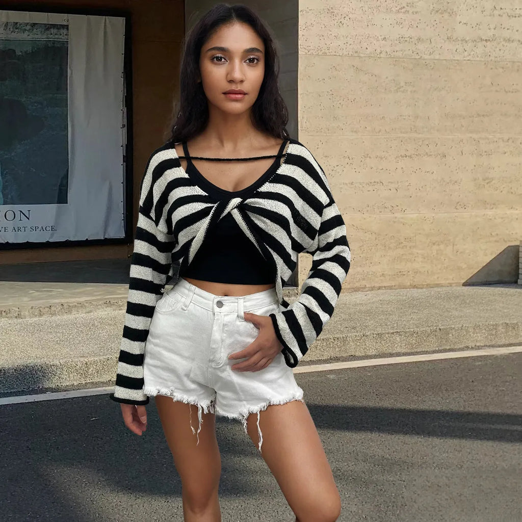 A striped long-sleeved pullover sweater with a cropped front and back design, shown in a selected colour.