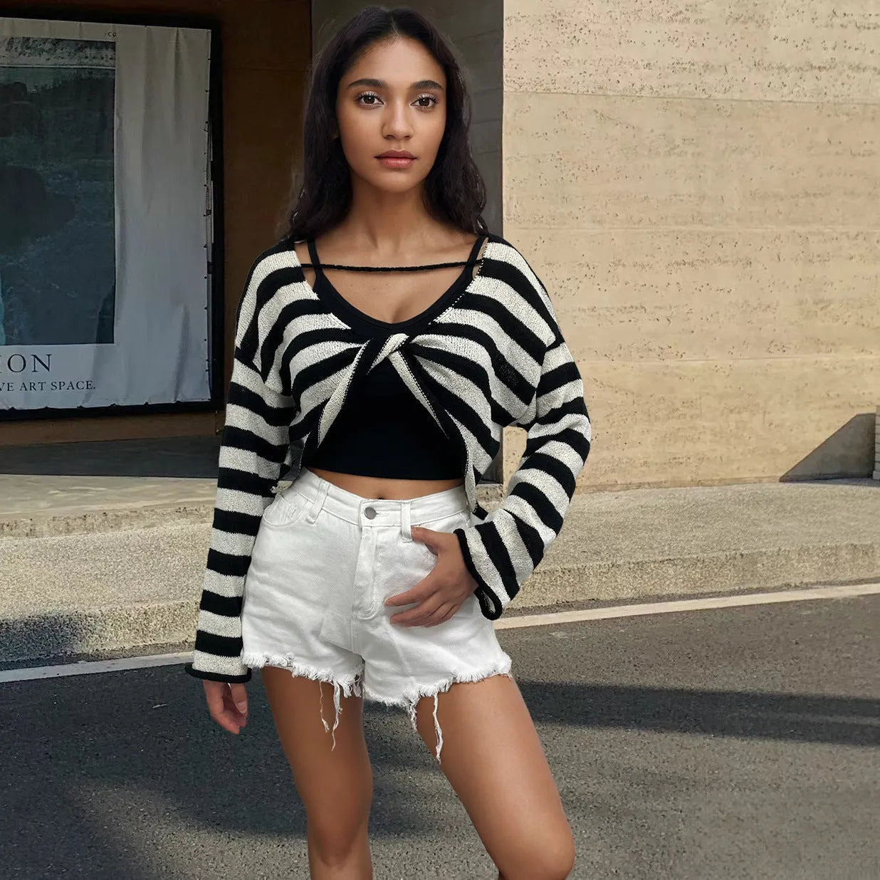 A striped long-sleeved pullover sweater with a cropped front and back design, shown in a selected colour.
