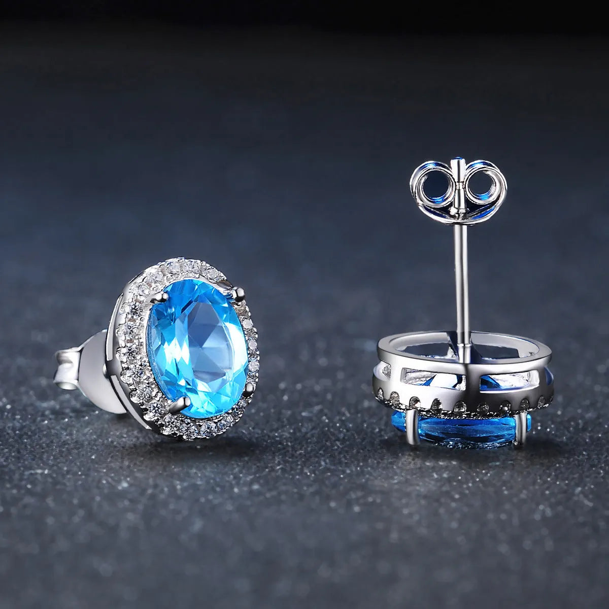 Geometric design 925 sterling silver jewellery set with blue topaz, showing earrings, ring, pendant and necklace.