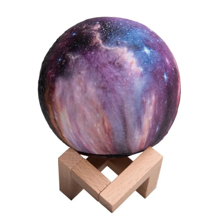 3D printed spherical moon night light with textured surface, shown with remote control.