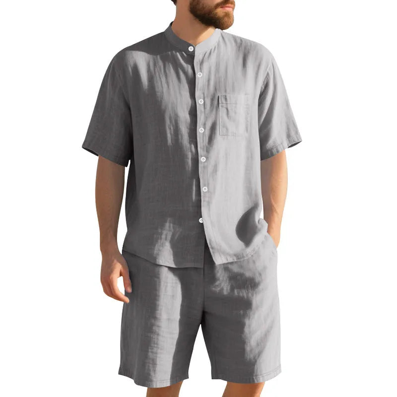 Man wearing a light blue linen blend short sleeve shirt and matching shorts, a casual summer two-piece suit.