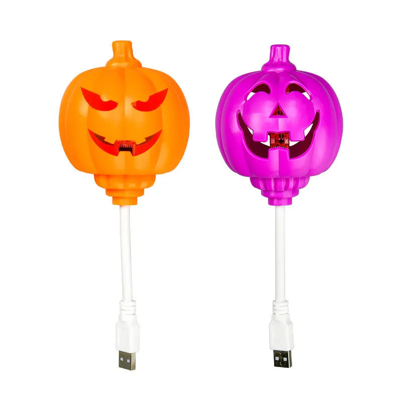 Plastic pumpkin-shaped USB lamp emitting purple or yellow light, 8.3cm wide.