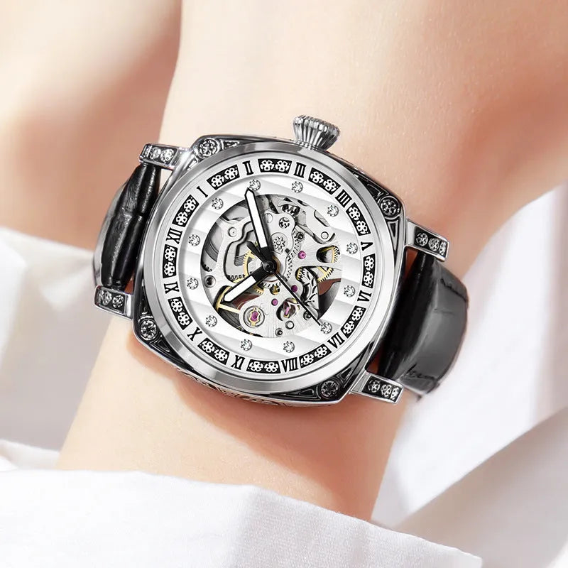 Mechanical watch with luminous hands on a leather strap, stainless steel case, shown in black colour.
