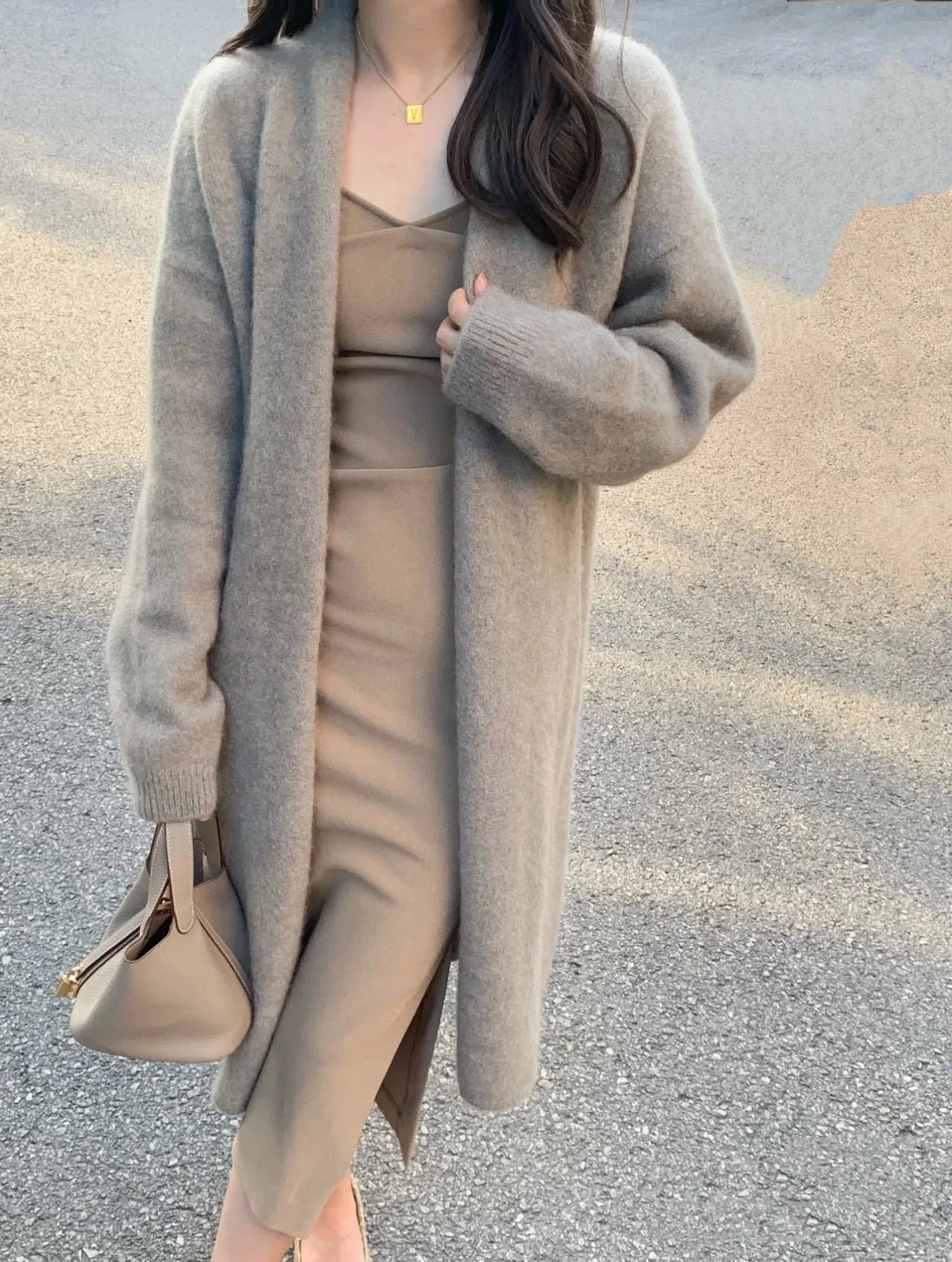 Women's knitted V-neck cardigan in loose fit showing mid-length silhouette and long sleeves