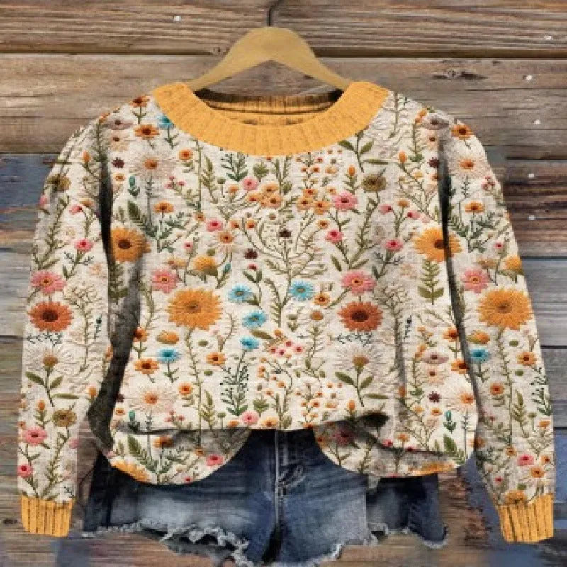 A round neck casual sweater with a small digital floral print, shown in one of thirteen available colours.