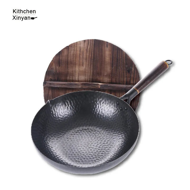Black traditional iron wok pan with wooden handle and induction base