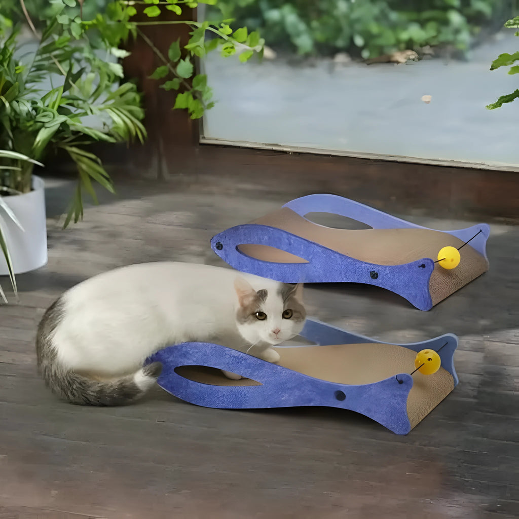 Blue fish-shaped cat scratcher with corrugated paper surface, bell toys, and wavy lounge area