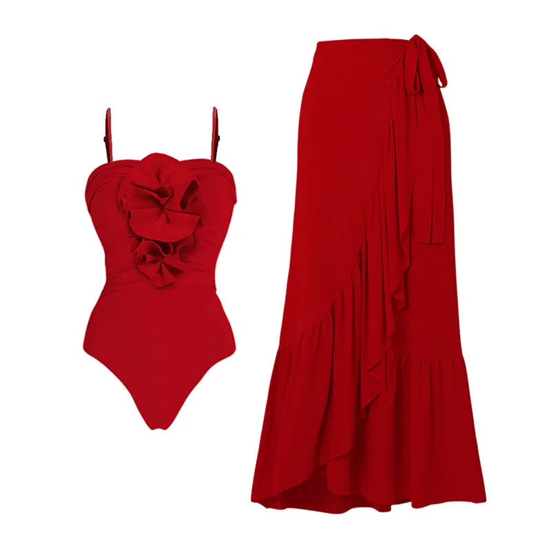 Red women's V-neck one-piece swimsuit with detachable flower and matching skirt on beach