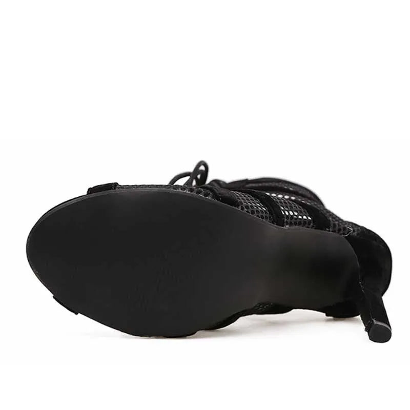 Black suede women's lace-up high heel shoes with 11.5cm heel on wooden floor