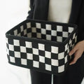 Checkerboard patterned grey and white felt folding storage box with woven design.