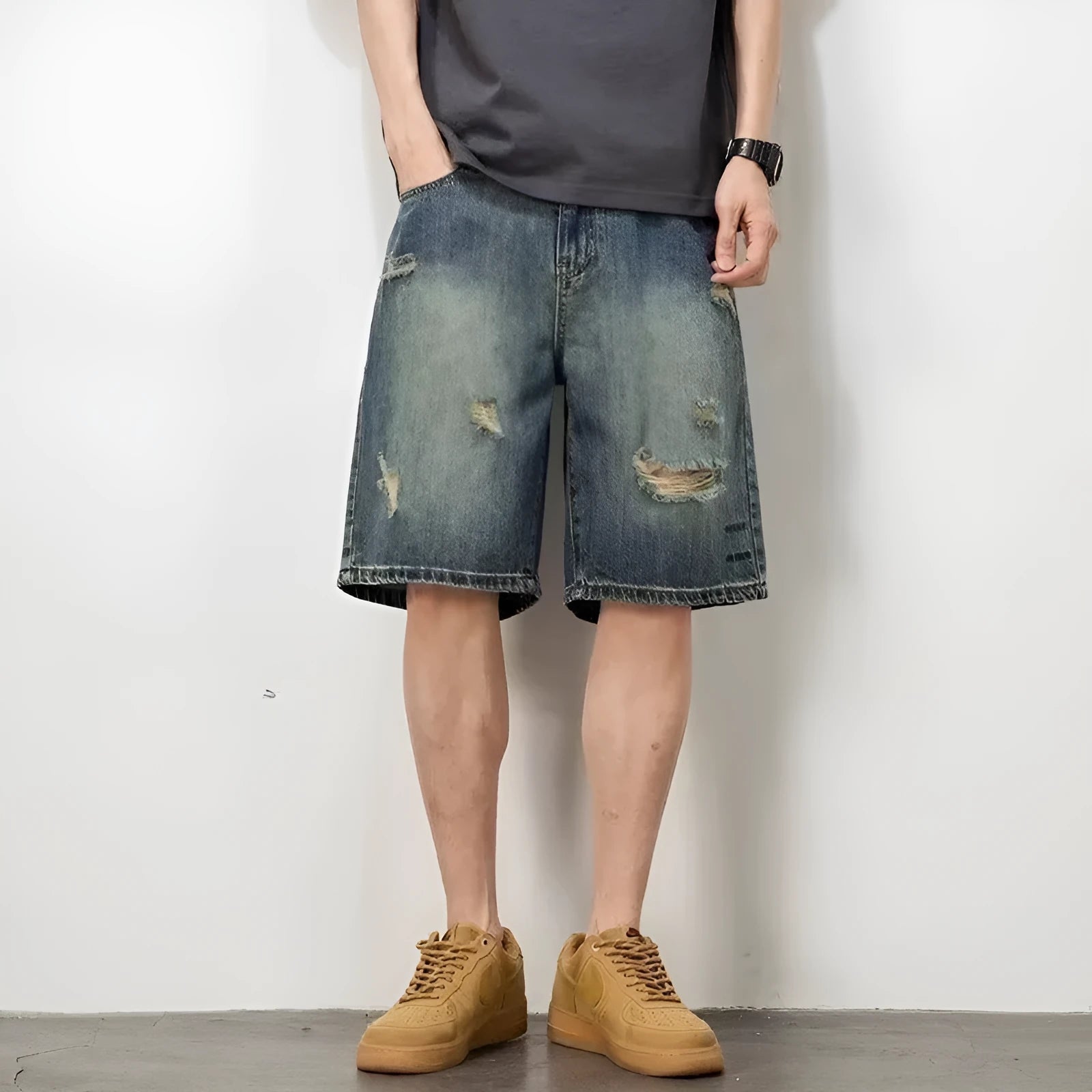 Men's blue distressed denim shorts with a straight leg and retro hole detailing.