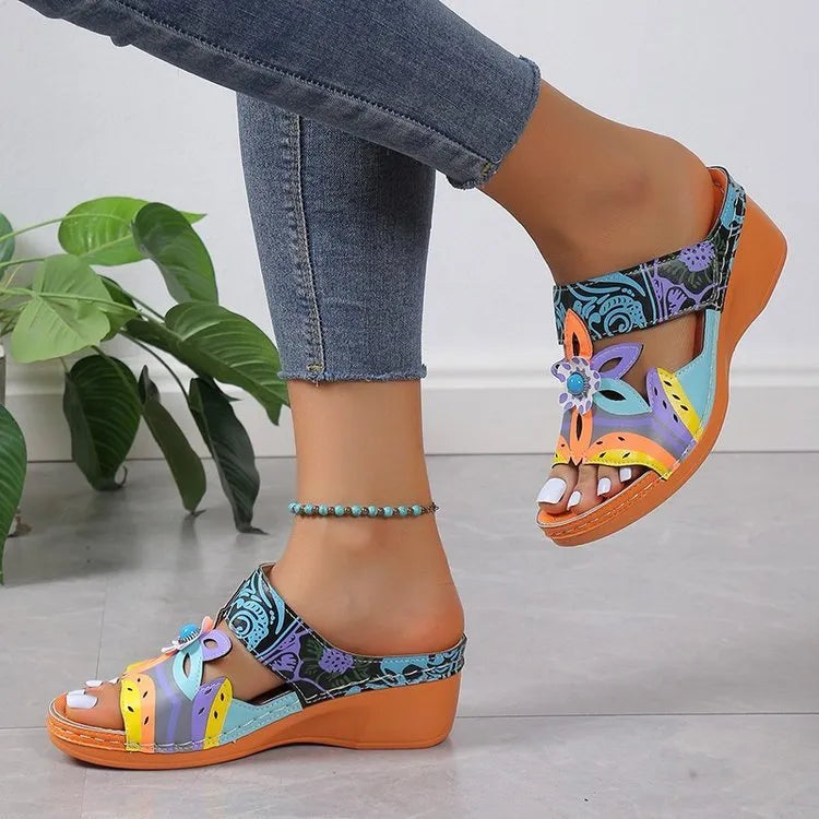 Women's ethnic totem pattern slippers with wedge heel on a solid rubber sole, shown in purple cowhide.