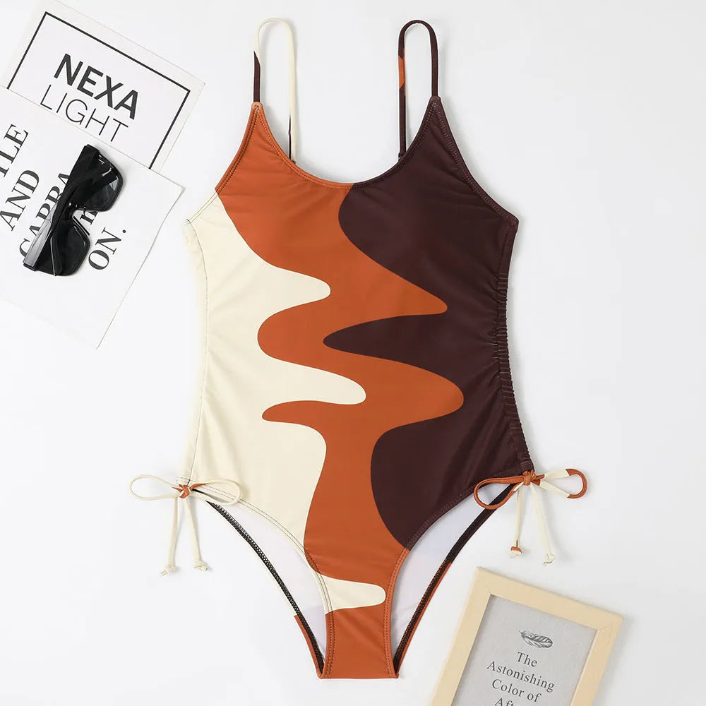 Women's sleeveless backless one-piece swimsuit in blue, shown on a mannequin.